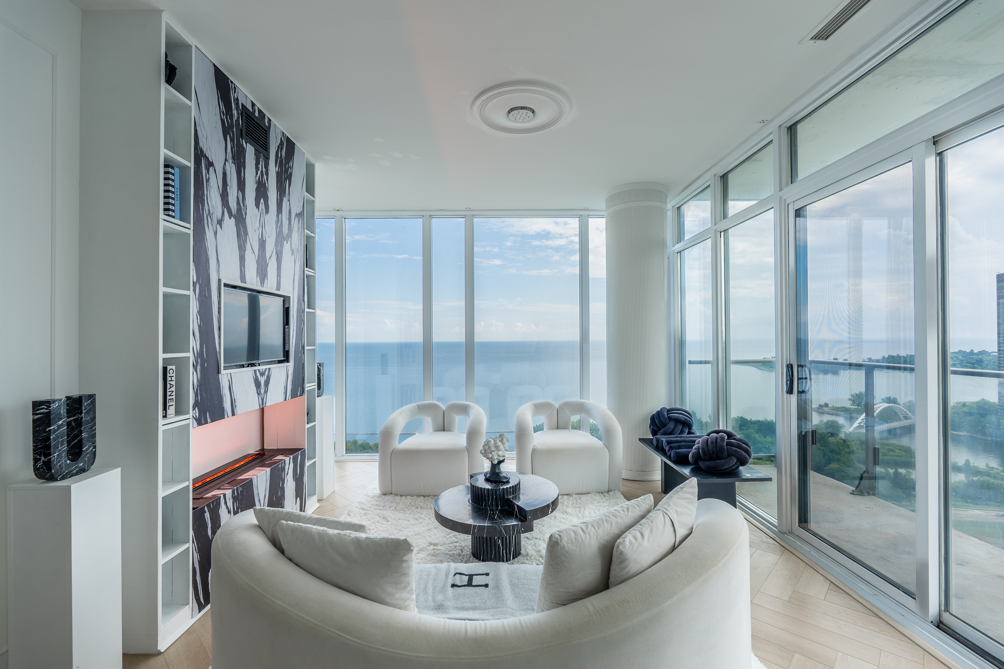 Living room with floor-to-ceiling windows overlooking Lake Ontario